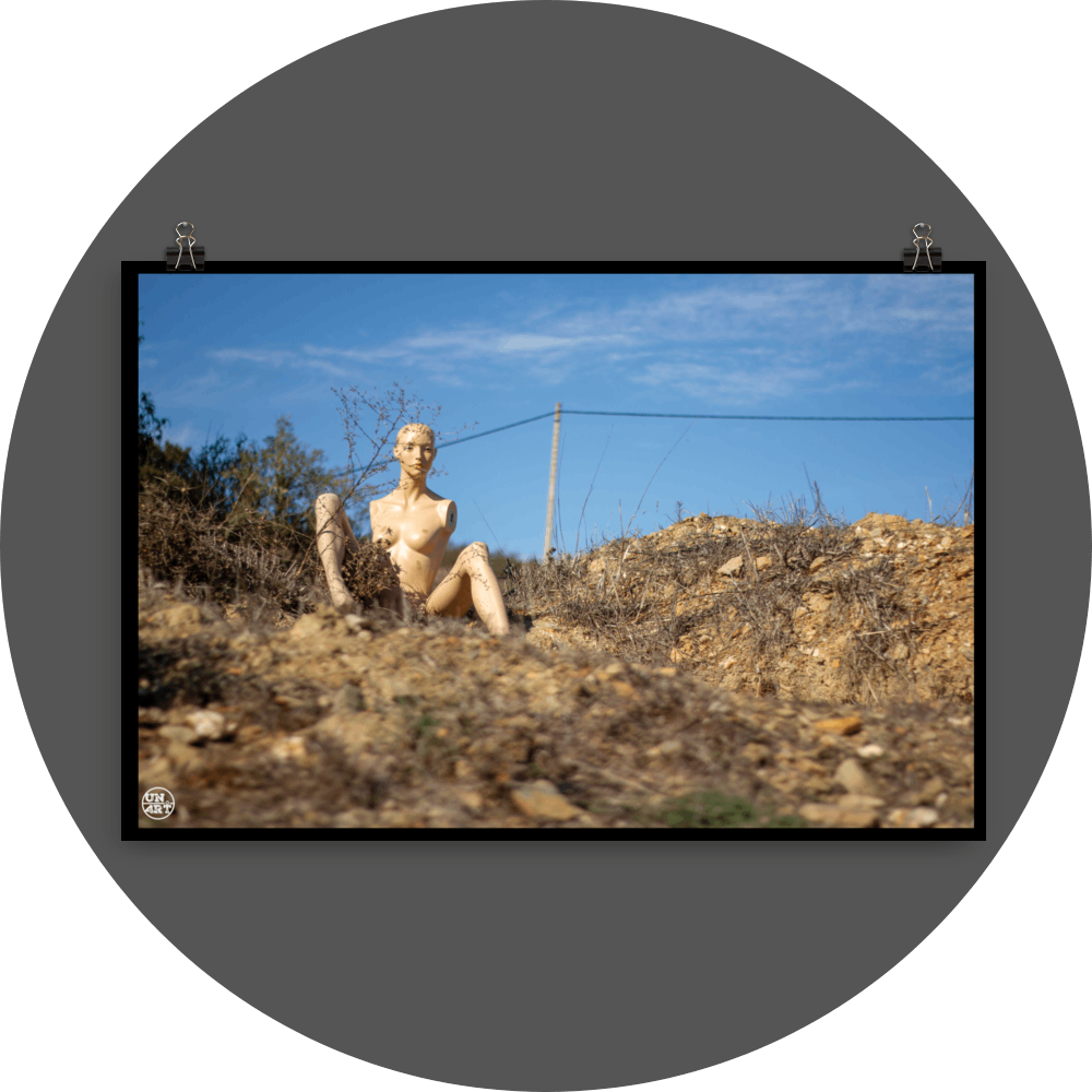 un4rt - almost human gallery poster mockup picture with a mannequin sitting outdoor on dry land in between brown grass. blue sky and a power line in the backround.