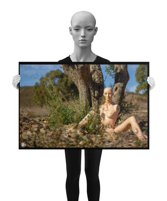 un4rt - almost human gallery poster mockup picture with a mannequin sitting outdoor in front of an old olive tree trunk. the poster is held by a mannequin.
