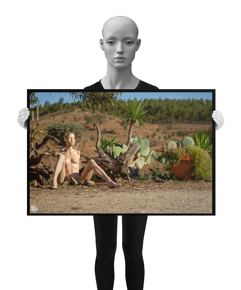 un4rt - almost human gallery poster mockup picture with a mannequin sitting outdoor in front of some plants. the poster is held by a mannequin.