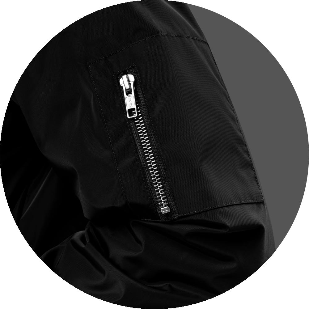 un4rt - the image shows details of a black bomber jacket with a pocket and a zipper on the left arm.