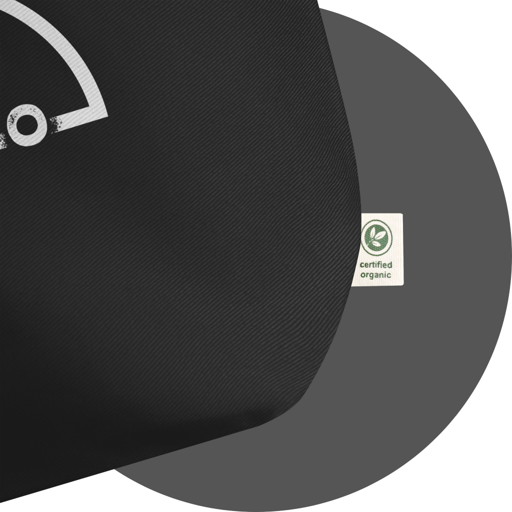 un4rt - the image shows a black cotton tote bag with a small part of a big white print of the upper part of the "UN4RT"-logo on it. a white label is attached to the bag. the label says "certified organic".