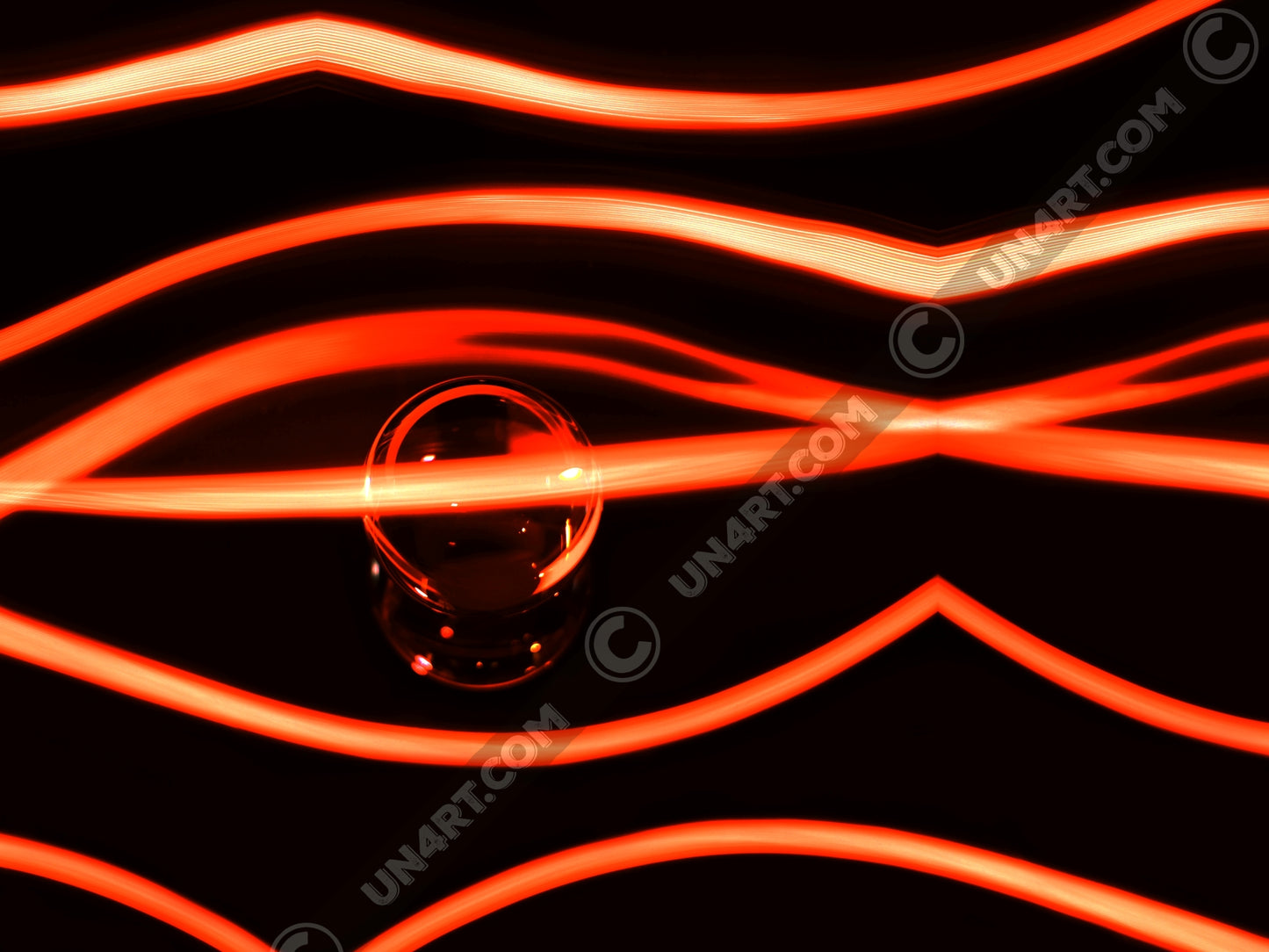 un4rt - the photographie has a black background with a glasball in the middle, placed on a mirror. the glasball is reflecting red light. various red lightlines around the glasball.