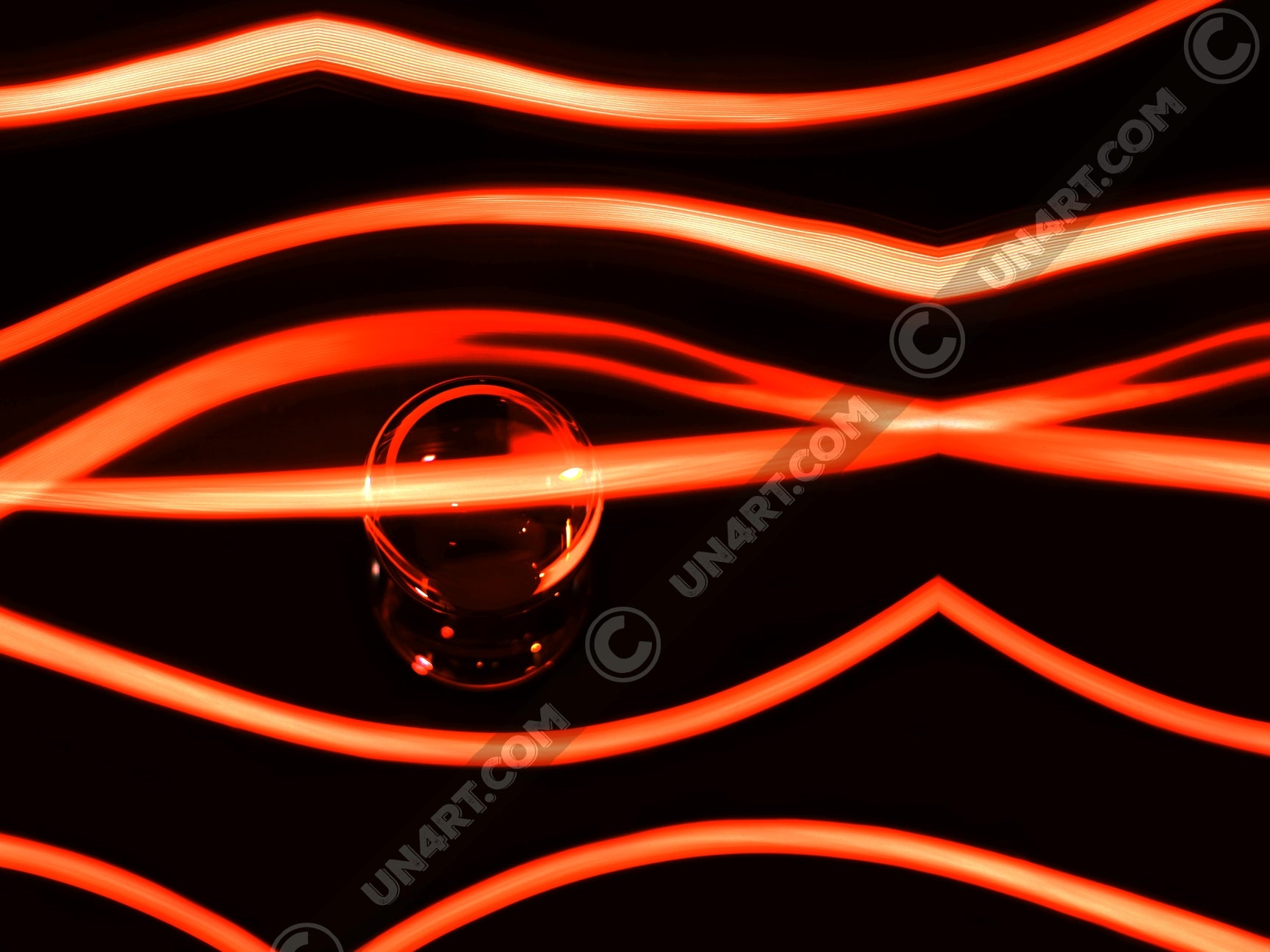 un4rt - the photographie has a black background with a glasball in the middle, placed on a mirror. the glasball is reflecting red light. various red lightlines around the glasball.