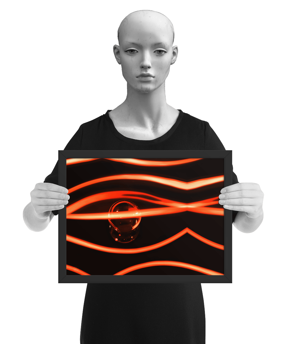 un4rt - the photographie has a black background with a glasball in the middle, placed on a mirror. the glasball is reflecting red light. various red lightlines around the glasball. the image is framed and presented by a mannequin in black and white.