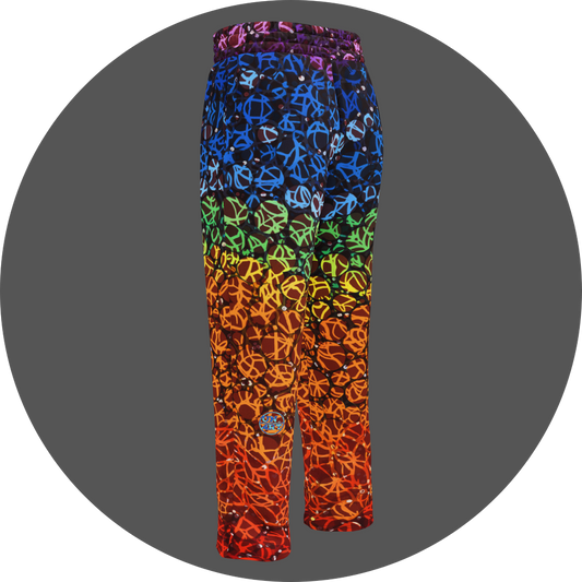UN4RT chakra dots all-over-print jogging pants back left view – rainbow gradient sweatpants with anarchic graffiti lettering in purple, blue, green, yellow and orange tones, scattered white rhinestone dots, small UN4RT logo at lower leg, elasticated waistband, straight leg cut.