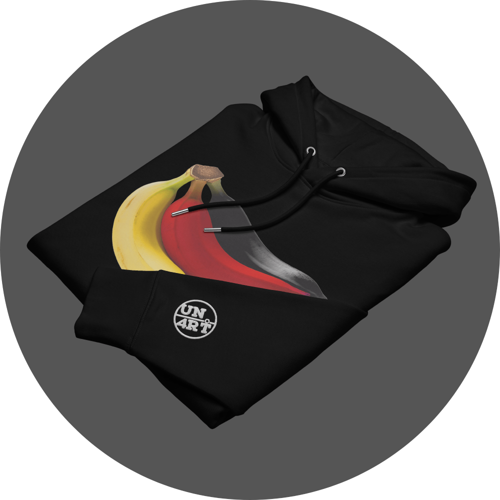 un4rt - the image shows the front of a folded black cotton hoodie with a print on the breast. the print shows three bananas colored in black, red and yellow. the left arm shows a white embroidery of the "UN4RT"-logo.