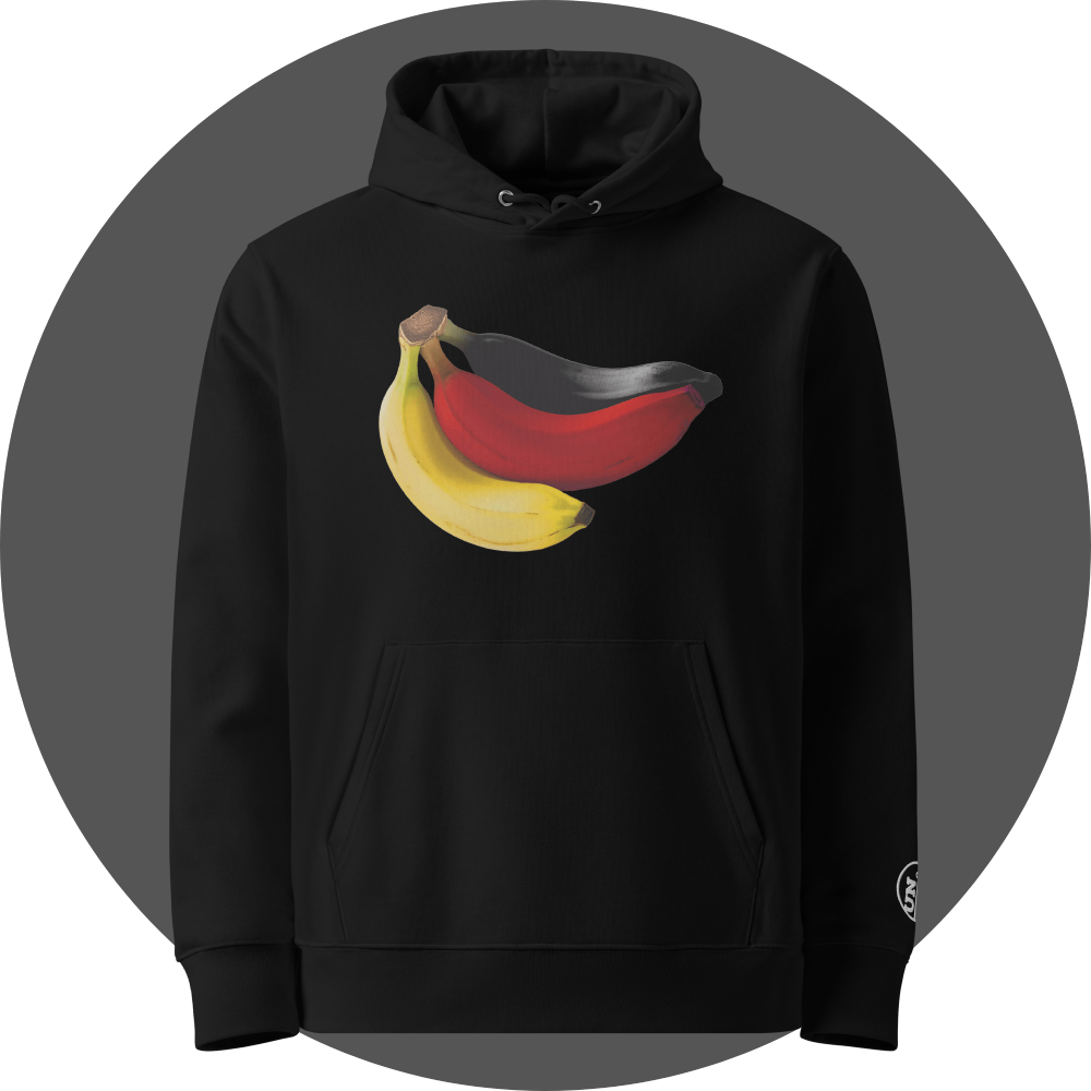 un4rt - the image shows the front of a black cotton hoodie with a print on the breast. the print shows three bananas colored in black, red and yellow. the left arm shows a part of a white embroidery of the "UN4RT"-logo.