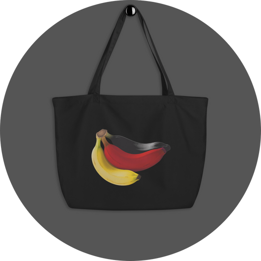 un4rt - the image shows one side of a black cotton tote bag with a big print on it. the print shows three bananas colored in black, red and yellow.
