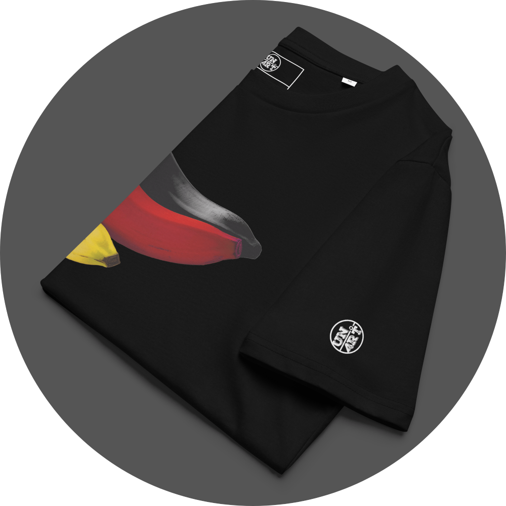 un4rt - the image shows the left half of the front of a folded black cotton t-shirt with a print on the breast. the print shows parts of three bananas colored in black, red and yellow. the left arm shows a white print of the "UN4RT"-logo.