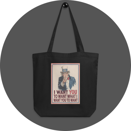 un4rt - the image shows a black cotton tote bag with an edited picture of a famous "uncle sam" painting where he is pointing at the viewer with his index finger. the picture is framed with red and blue lines. the text below the picture reads: "I want you to want what  want you to want".