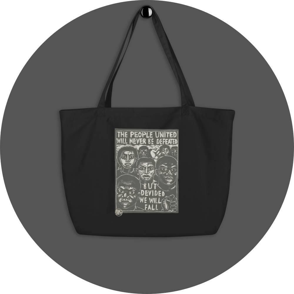 un4rt - the image shows a black cotton tote bag with a big 2 colored print in the center. the print shows prostestors of different races. the text reads: "the people united will never be defeated - but devided we will fall".