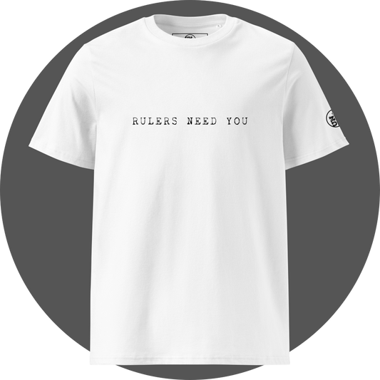 un4rt - the image shows the front of a white cotton t-shirt with printed black letters on the upper area. the text reads: "rulers need you". a black "UN4RT"-logo is printed on the left sleeve, but only the upper part of the logo is visible.