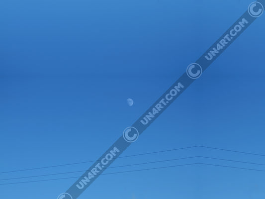 un4rt - the photographie shows a completely blue sky with a small moon in the center. some power lines cross the image on the bottom.