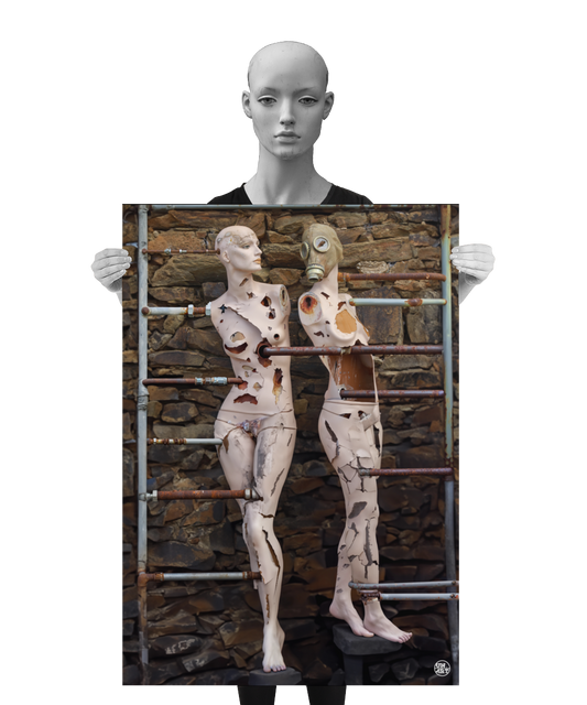 un4rt - a poster. combination of photographie and ai-art. two mannequins with massive signs of destruction in front of an old stone wall. both mannequins are connected with various rusty pipes. one of them is wearing a gas mask. a mannequin is holding the poster.