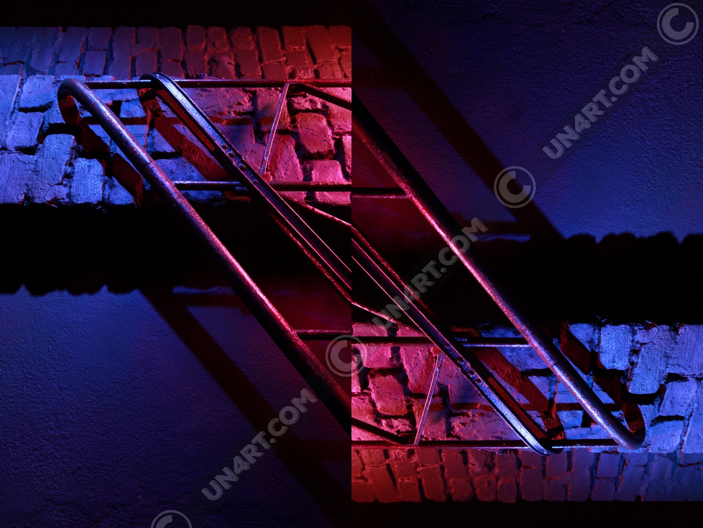 un4rt - the photographie is doubled and then mirrored. both photographies together create the final image. the image shows a brick wall and a wall with a handrail. the illumination changes from red to blue.