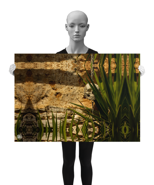 un4rt - a poster.  a mirror-framed photographie of a tiny skull hanging on a chain in front of an old wall. some parts of the skull are covered from a yucca. the poster is presented by a model in black and white.