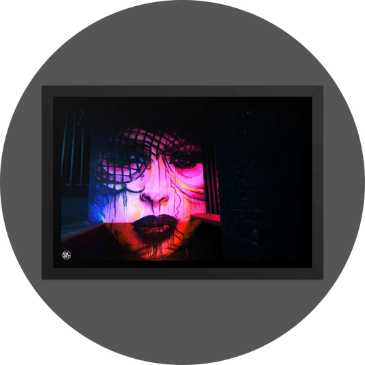 un4rt - the photographie shows a mural of a female face in various colors, pink, yellow, blue, orange. the face is surrounded by black walls, some made of bricks, some made of wood.