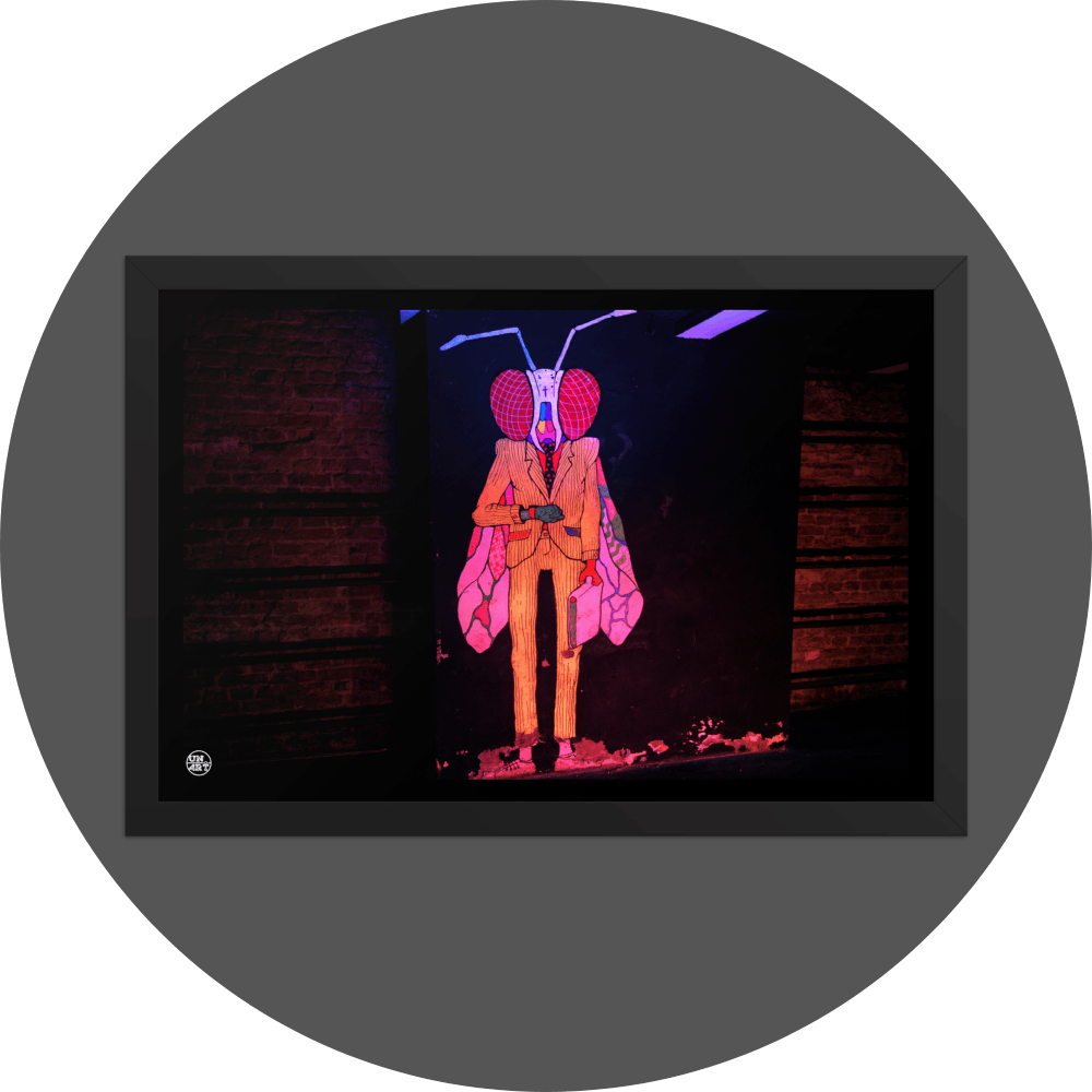 un4rt - the photographie shows a mural of a humanoid insect in a suit with a briefcase on a black wall. the creature is looking at a watch on his wrist. on both side of the black wall there re brick walls with fixed steel pipes. the creature is colorful with a yellow suit, red eyes colored wings and a white head.