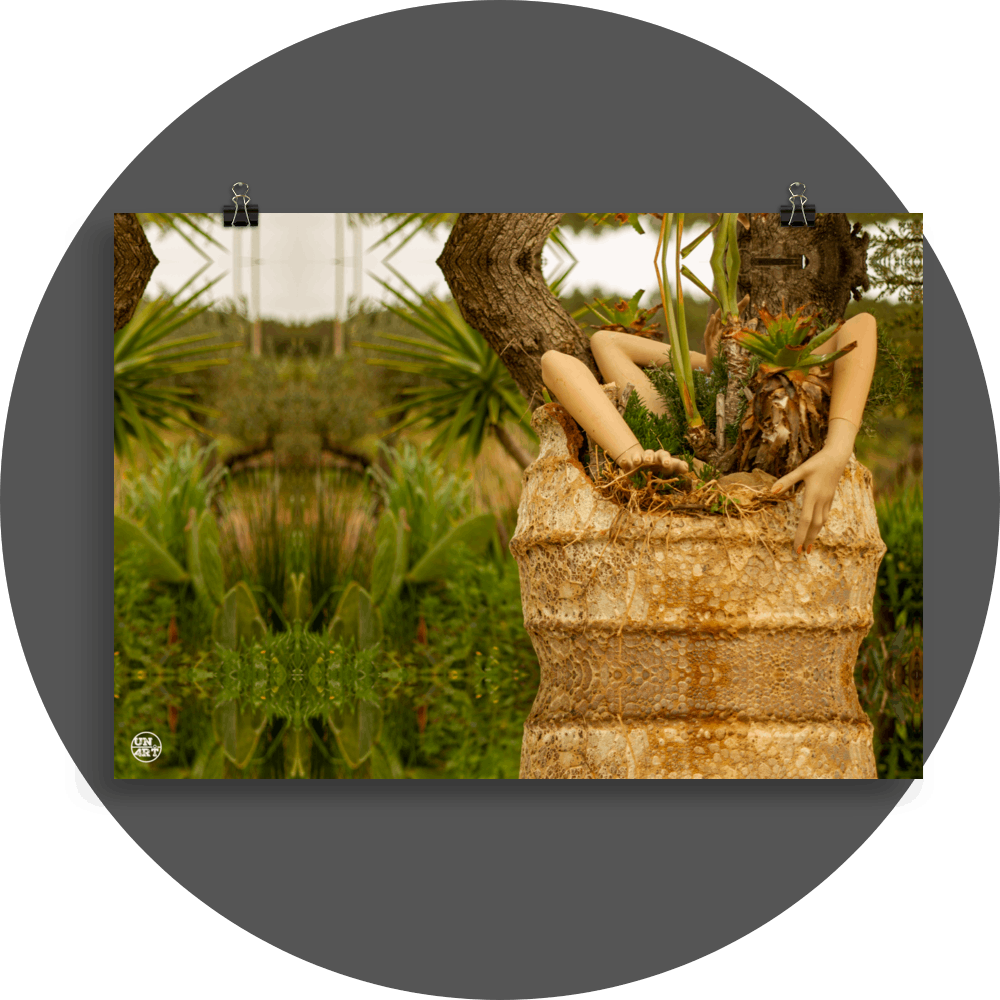 un4rt - a photographie that is mirrored on all sides. the image shows three arms coming out of a huge ancient vase. some plants are planted into the vase. two old tree trunks behind the vase. wild greenery and some hills in the background. the background is unsharp.