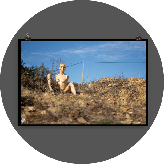 un4rt - almost human gallery poster mockup picture with a mannequin sitting outdoor on dry land in between brown grass. blue sky and a power line in the backround.