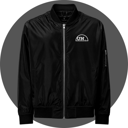 un4rt - the image shows the front of a black bomber jacket with a white embroidery of the upper part of the "UN4RT"-logo.
