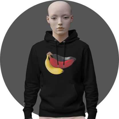 UN4RT black hoodie, large photorealistic banana bunch graphic in yellow, red and dark grey tones centered on chest, white drawstrings, UN4RT logo on right cuff, kangaroo pocket, male mannequin front view, grey circular background.