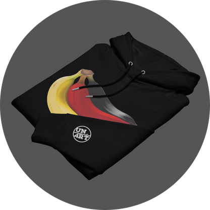 un4rt - the image shows the front of a folded black cotton hoodie with a print on the breast. the print shows three bananas colored in black, red and yellow. the left arm shows a white embroidery of the "UN4RT"-logo.