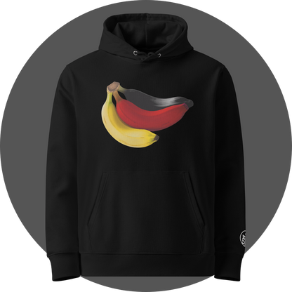 un4rt - the image shows the front of a black cotton hoodie with a print on the breast. the print shows three bananas colored in black, red and yellow. the left arm shows a part of a white embroidery of the "UN4RT"-logo.