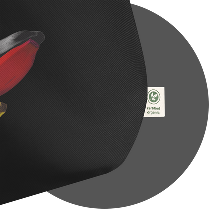 un4rt - the image shows details of a black cotton tote bag with a print on it. the print is only partially visible and shows the endings of three bananas, colored in black, red and yellow. a white label with a green print is attached to the tote bag. the print on the label says: "certified organic".
