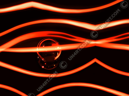 un4rt - the photographie has a black background with a glasball in the middle, placed on a mirror. the glasball is reflecting red light. various red lightlines around the glasball.