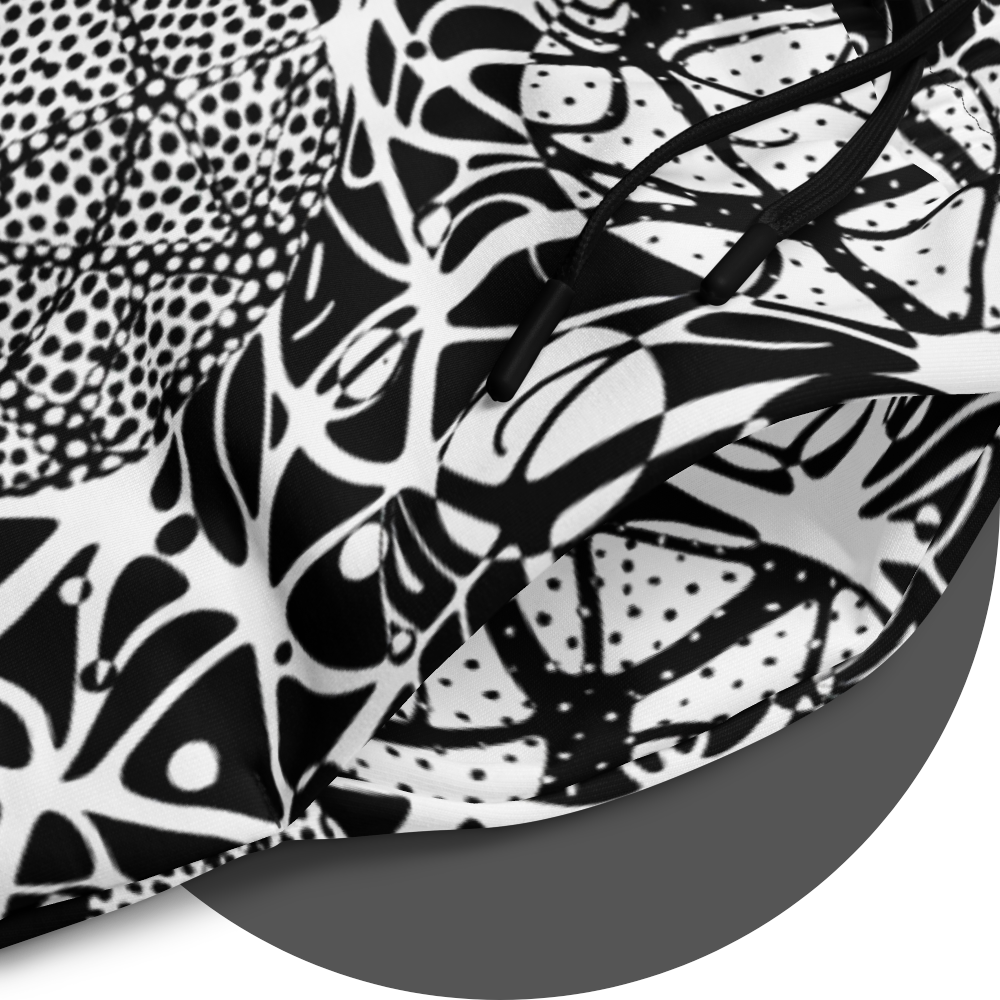 UN4RT brainbubbles all-over-print jogger detail – circular close-up of white fabric showing dense black organic network pattern of curved lines, stippled dot cluster circles and cell-like enclosed forms with fine line details, black drawstrings visible at waistband.