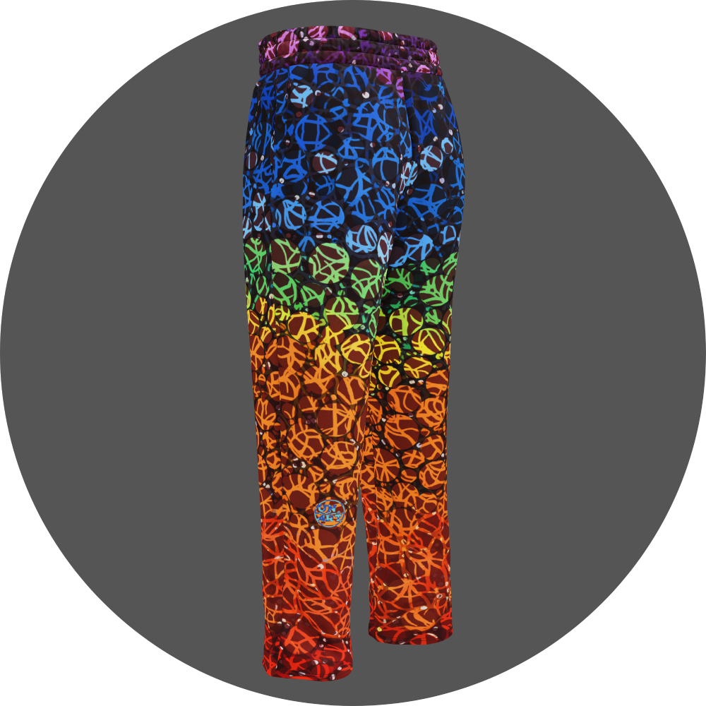 UN4RT chakra dots all-over-print jogging pants back left view – rainbow gradient sweatpants with anarchic graffiti lettering in purple, blue, green, yellow and orange tones, scattered white rhinestone dots, small UN4RT logo at lower leg, elasticated waistband, straight leg cut.