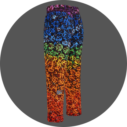 UN4RT chakra dots all-over-print jogging pants back left view – rainbow gradient sweatpants with anarchic graffiti lettering in purple, blue, green, yellow and orange tones, scattered white rhinestone dots, small UN4RT logo at lower leg, elasticated waistband, straight leg cut.