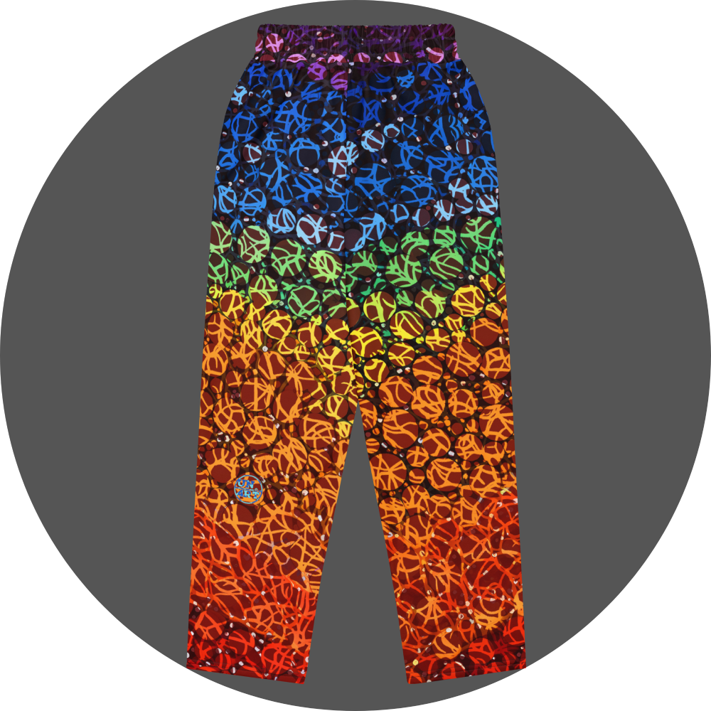 UN4RT chakra dots all-over-print jogger back flat – rainbow gradient sweatpants with anarchic graffiti lettering and circle motifs, vertical colour flow from deep purple and blue at waistband through green, yellow, orange to deep red at hem, scattered white rhinestone dots, small UN4RT logo at lower left leg, elasticated waistband.