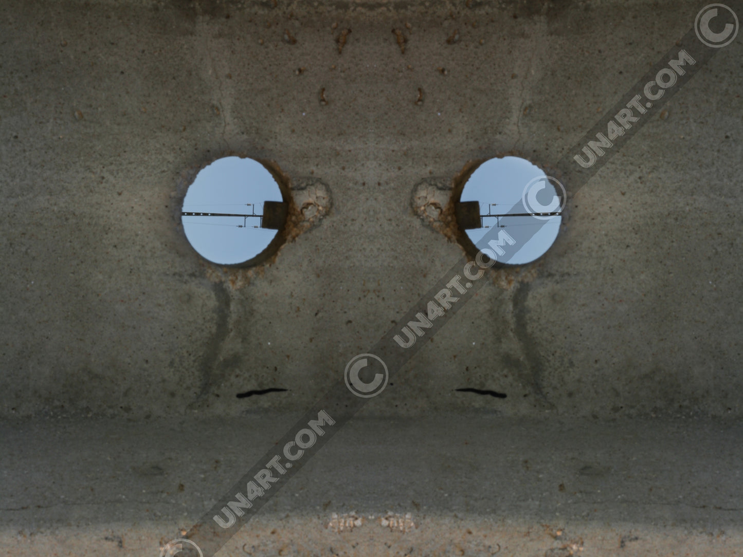 un4rt - the photographie shows a section of an concrete pole with a holes. the whole image contains the photographie for 2 times and one of the photographies is mirrored.