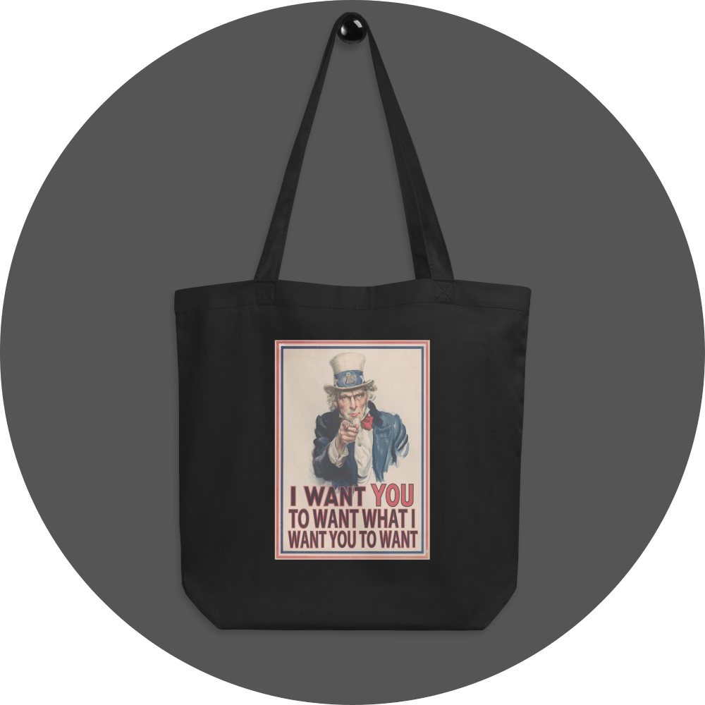 un4rt - the image shows a black cotton tote bag with an edited picture of a famous "uncle sam" painting where he is pointing at the viewer with his index finger. the picture is framed with red and blue lines. the text below the picture reads: "I want you to want what  want you to want".