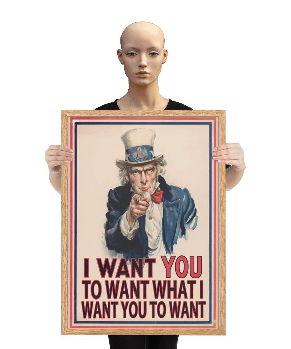un4rt - the image shows a mannequin holding a framed poster with an edited picture of a famous "uncle sam" painting where he is pointing at the viewer with his index finger. the picture is framed with red and blue lines. the text below the picture reads: "I want you to want what  want you to want".