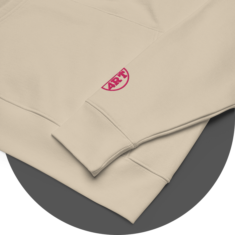 un4rt - the images shows details of an oystrich colored cotton hoodie with a pink colored embroidery of the "UN4RT"-logo on the left sleeve. only the lower part of the logo is visible.