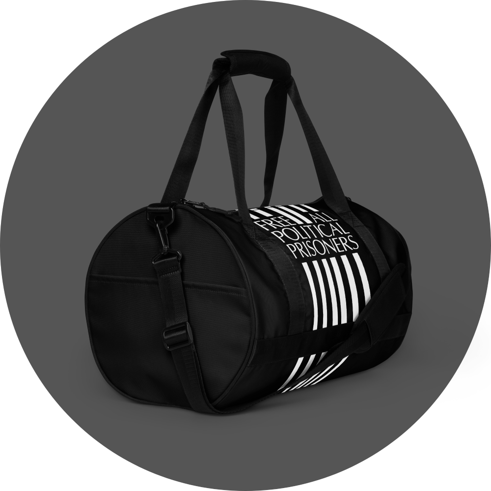 un4rt - the image shows the center and one side of a black tubular gym bag with six vertical white stripes in the middle of the center. the stripes are interrupted with text. the text reads:"free all political prisoners". the side has a pocket.