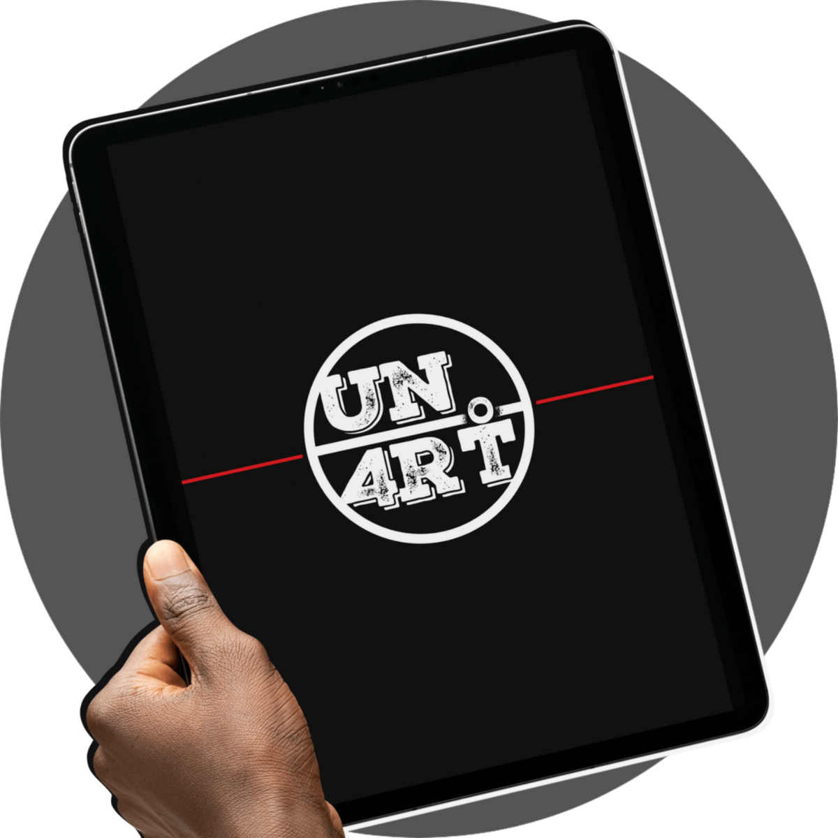 UN4RT Cadernos – collection mockup of a black tablet held in a dark hand displaying the UN4RT circular badge logo in distressed white lettering bisected by a horizontal red line on a solid black screen, dark editorial brand identity digital collection mockup on a grey circular background
