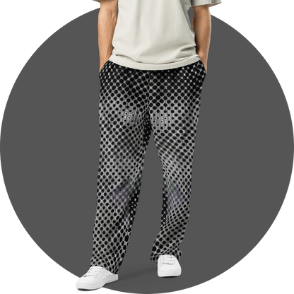 UN4RT black and white all-over print jogger pants, dense repeating circle and dot grid pattern with optical illusion depth effect, tapered fit, grey circular background.