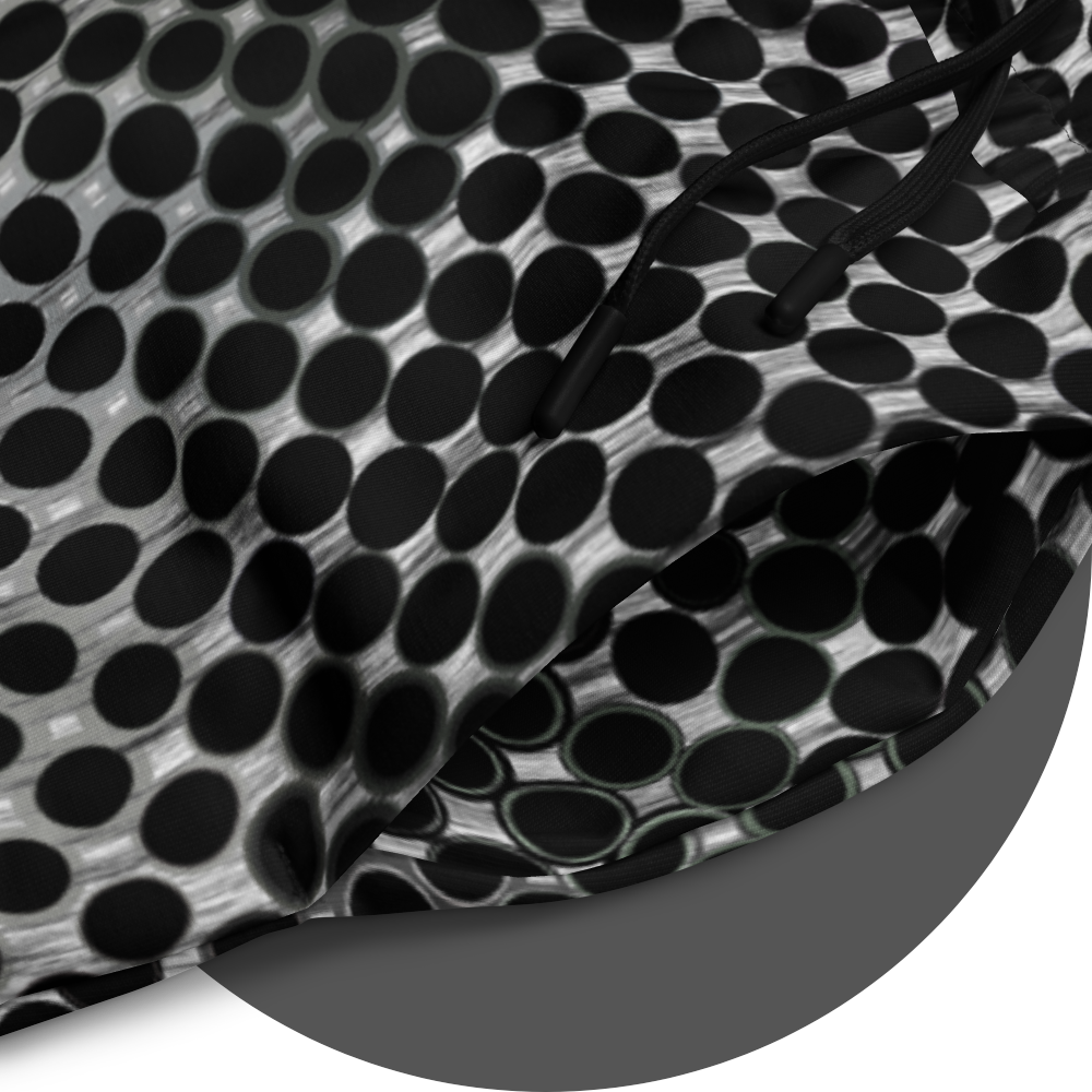 UN4RT doterium jogging pants fabric detail – circular close-up of all-over-print showing black circle dot pattern on white fabric with black drawstring visible, fine halftone gradient from solid to hollow ring forms.