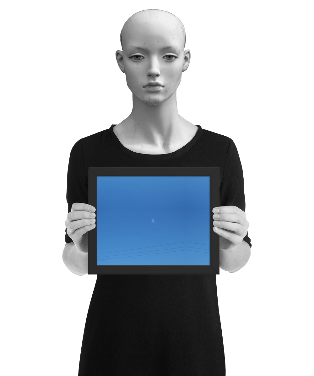 un4rt - the photographie shows a completely blue sky with a small moon in the center. some power lines cross the image on the bottom. the image is framed and presented by a mannequin in black and white.