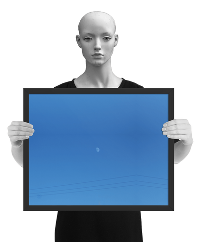 un4rt - the photographie shows a completely blue sky with a small moon in the center. some power lines cross the image on the bottom. the image is framed and presented by a mannequin in black and white.