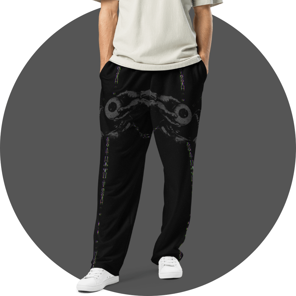 UN4RT black all-over print jogger pants, dark abstract symmetric ink blot and hand-holding-eyeball motif with subtle chromatic glitch streaks on black, straight fit, front view, grey circular background.