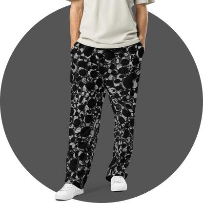 UN4RT black and grey all-over print jogger pants, dense repeating circular and organic bubble pattern in black and grey tones, straight fit, grey circular background.