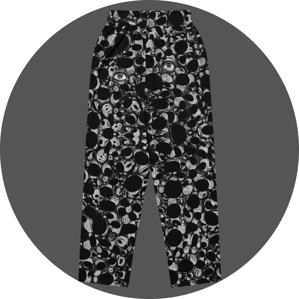 UN4RT eyesolation all-over-print jogging pants back flat – black sweatpants with dense abstract pattern of black organic blob shapes and grey brushstroke texture, elasticated waistband, small UN4RT logo at lower leg, subtle eye motif visible in print.