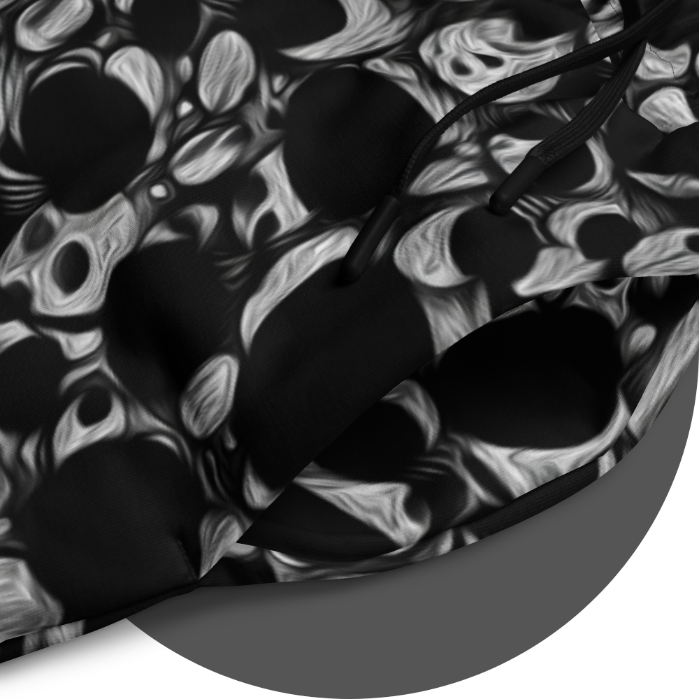 UN4RT eyesolation jogger detail – circular close-up of all-over-print showing dense abstract pattern of black organic blob shapes with grey brushstroke texture on black fabric, black drawstring visible at waistband opening.