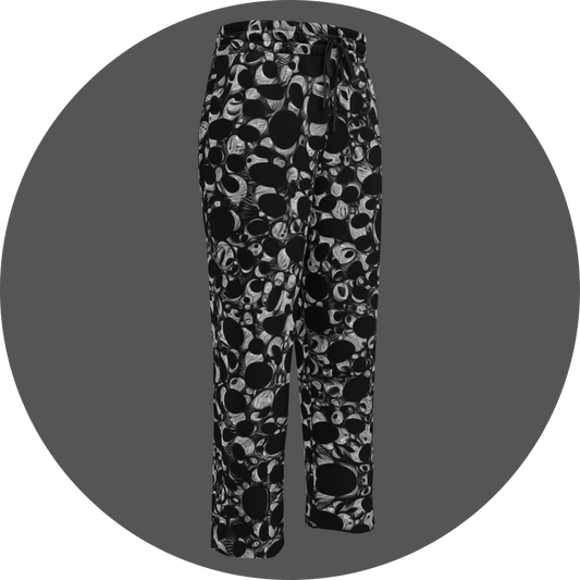 UN4RT eyesolation all-over-print jogging pants front right view – black sweatpants with dense abstract pattern of black organic blob shapes and grey brushstroke texture, elasticated drawstring waistband, straight leg cut.