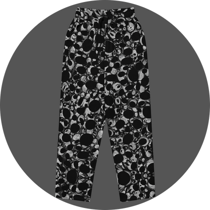 UN4RT eyesolation all-over-print jogging pants front flat – black sweatpants with dense abstract pattern of black organic blob shapes and grey brushstroke texture, elasticated drawstring waistband.